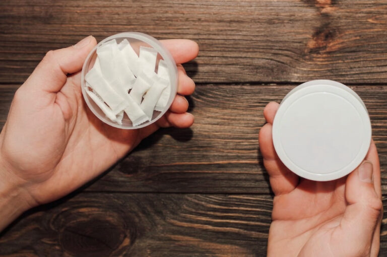 man holding a tin of zonnic pouches