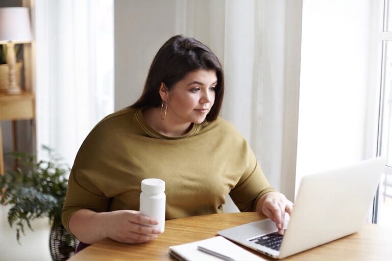 Woman holding contrave tablets